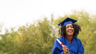 young smiling woman on graduation day wearing.width