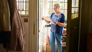 Elderly woman appears concerned about letter .width qNgArMh.jpg