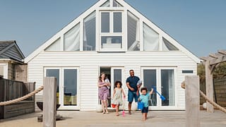 Family emerging from a beach house wvTXk.width .jpg