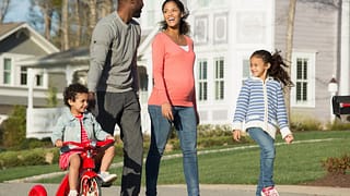 Family walking through suburban neighborhood .width .jpg