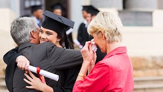 Female college grad hugging dad XOFFTxD.width .jpg