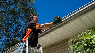 Man cleaning homes gutters fPDNzI.width .jpg