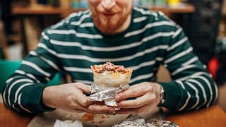 Man enjoying a burrito. JiUnfG.width .jpg