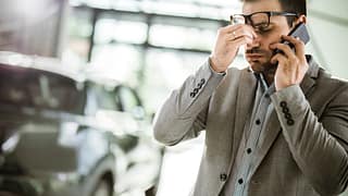 Man in apparent distress on phone with vehicl.width .jpg