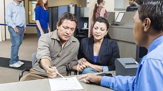 Native American couple looks over documents w.width .jpg