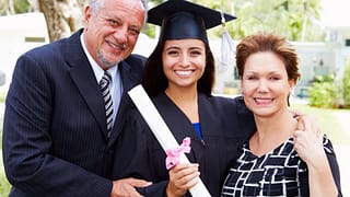 Parents with college student at graduation .width hEWEQM.jpg