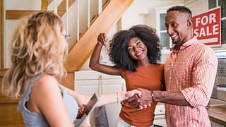 Real estate agent congratulating a new owner .width GeGttL.jpg