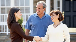 Realtor shaking hands with mature couple outs.width dGtEi.jpg