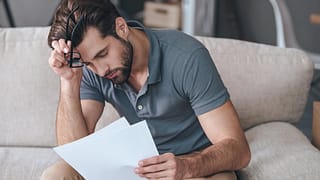 Upset man with bills wEKVP.width .jpg