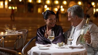 Well dressed mature couple enjoying wine with.width Uwlolj.jpg