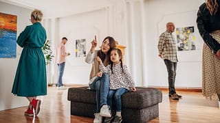 Woman and daughter looking at art in a museum.width deOwmAd.jpg