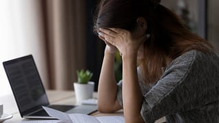 Woman appearing upset with head in her hands .width qqzych.jpg