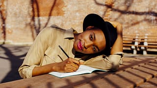 Woman in park writing in journal QsKsNb.width .jpg