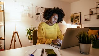 Woman using laptop at home for work or study .width .jpg