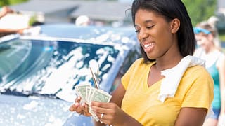 Young adult woman counts cash at car wash jbm.width .jpg