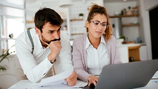 Young couple skeptically looks at information.width DDgOhN.jpg