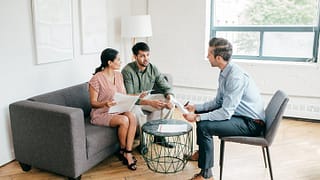 couple with realtor and paperwork KsVHLK.width .jpg