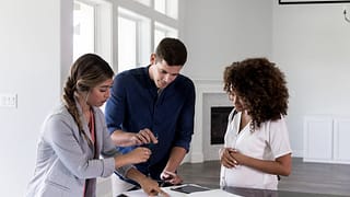 couple with realtor signing papers.width .jpg