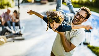 dad holding son in air FBKHHl.width .jpg