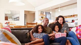family watching movie on couch.width .jpg