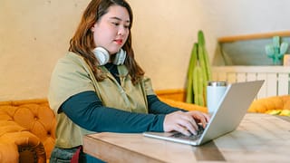 female college student at home on laptop.width .jpg