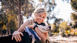 getty happy with a dog smiling.jpg