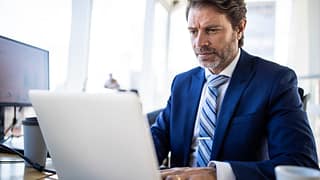 man middle aged business suit serious laptop gettyimages .jpg