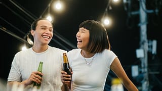 man and woman drinking beer on rooftop FlmiMS.width .jpg
