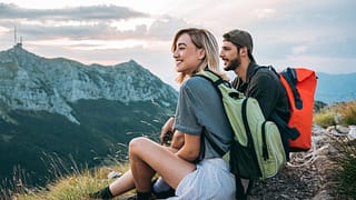 man and woman hikers on mountaintop.width .jpg
