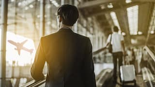 man with suitcase in airport XNAsLY.width .jpg
