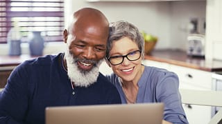 older couple at laptop smiling gettyimages .jpg