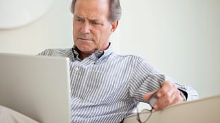 older man laptop serious expression looks unhappy gettyimages .jpg