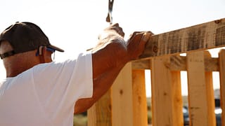 person building fence PbzLOJ.width .jpg
