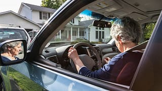 person driving car in front of house dLfSE.width .jpg