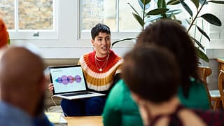 person leading meeting in office with laptop .width .jpg