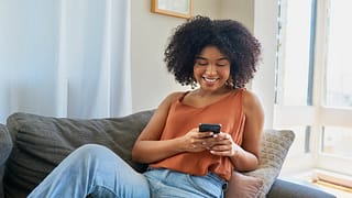 person on couch with phone TIHLN.width .jpg