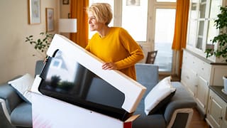 person unboxing new tv iIIanrE.width .jpg