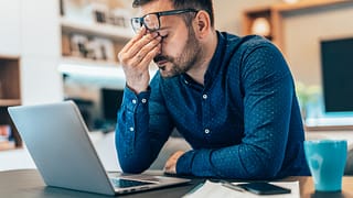 stressed person with hand on forehead.jpg