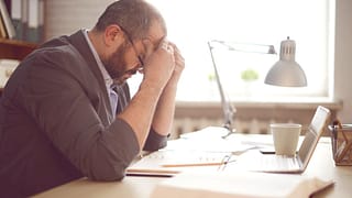 stressed man working at desk AnncGI.width .jpg