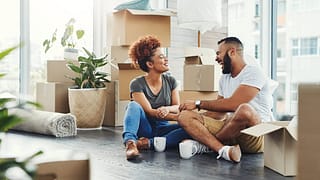 two people on floor between moving boxes kVBB.width .jpg