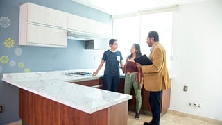 two people with realtor in kitchen XaHTHIU.width .jpg