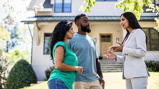 two people with realtor outside house KeFovDR.width .jpg