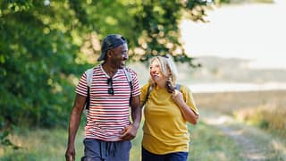 two smiling people hiking pHjfNub.width .jpg