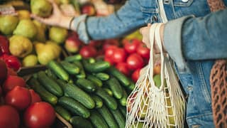 woman buying produce at grocery store.width .jpg