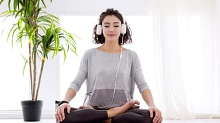 woman doing yoga with headphones.width .jpg