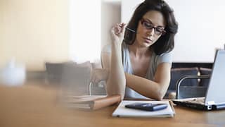 woman finance calculator laptop notebook Uo.width .jpg
