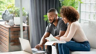 Couple sit and go over personal finances fTc.width .jpg