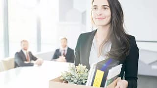 Happy businesswoman leaving job with box of b.width qZUZkS.jpg