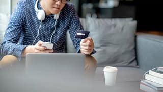 Man with credit card phone laptop TGXVGqd.width .jpg