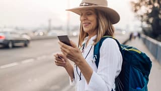 Mature woman holding her phone and a credit c.width UAbKy.jpg